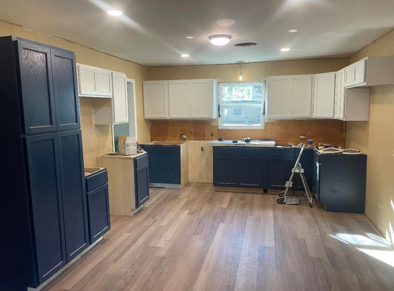 navy-blue-cabinets-mid-installation-exposed-plumbing What genuinely moves the number on a kitchen fitting quote