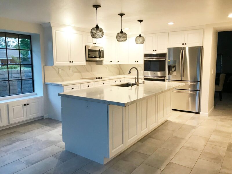 white-cabinets-marble-effect-island-stainless-appliances What's Included in a Worktop Installation -- and What Isn't