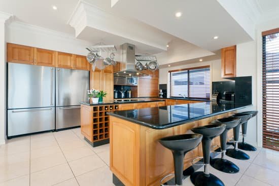 wooden-cabinets-black-granite-island-hanging-pot-rack Cabinets We Built Ourselves, Fitted by the Joiners Who Know Their Tolerances